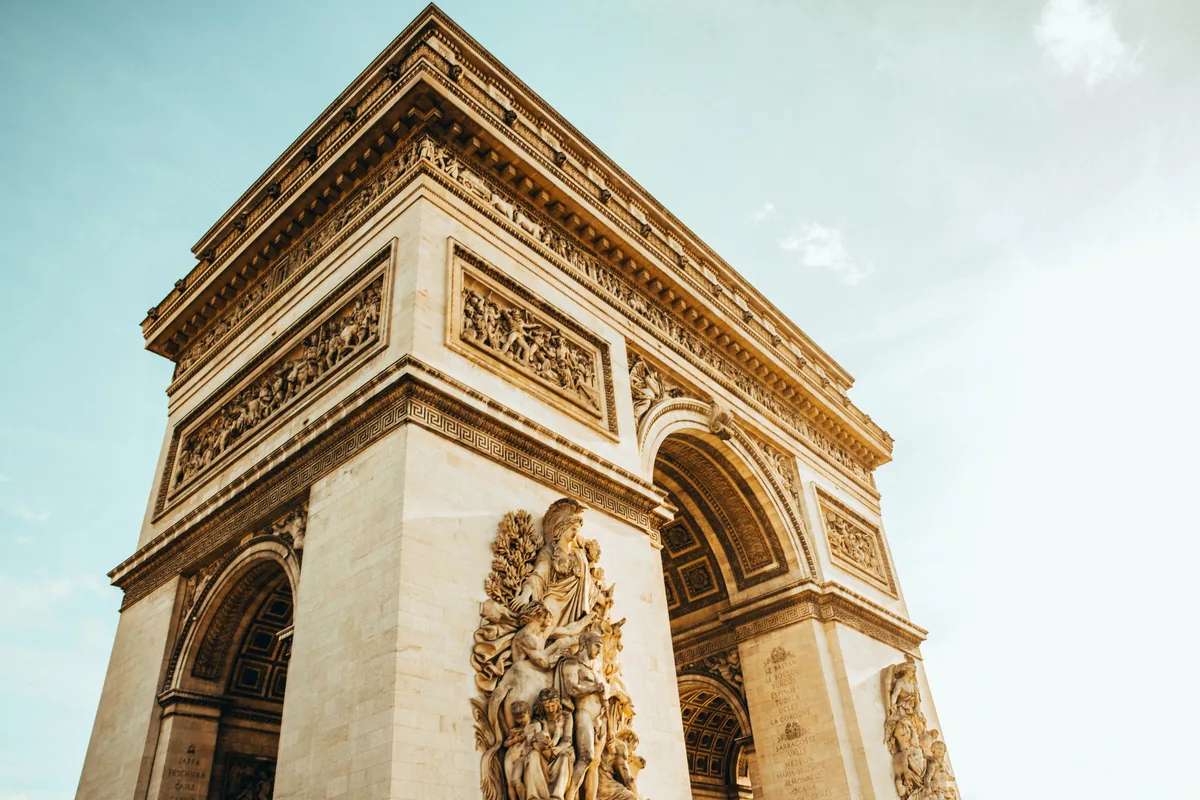 Looking up at the Arc de Triomphe from street level
